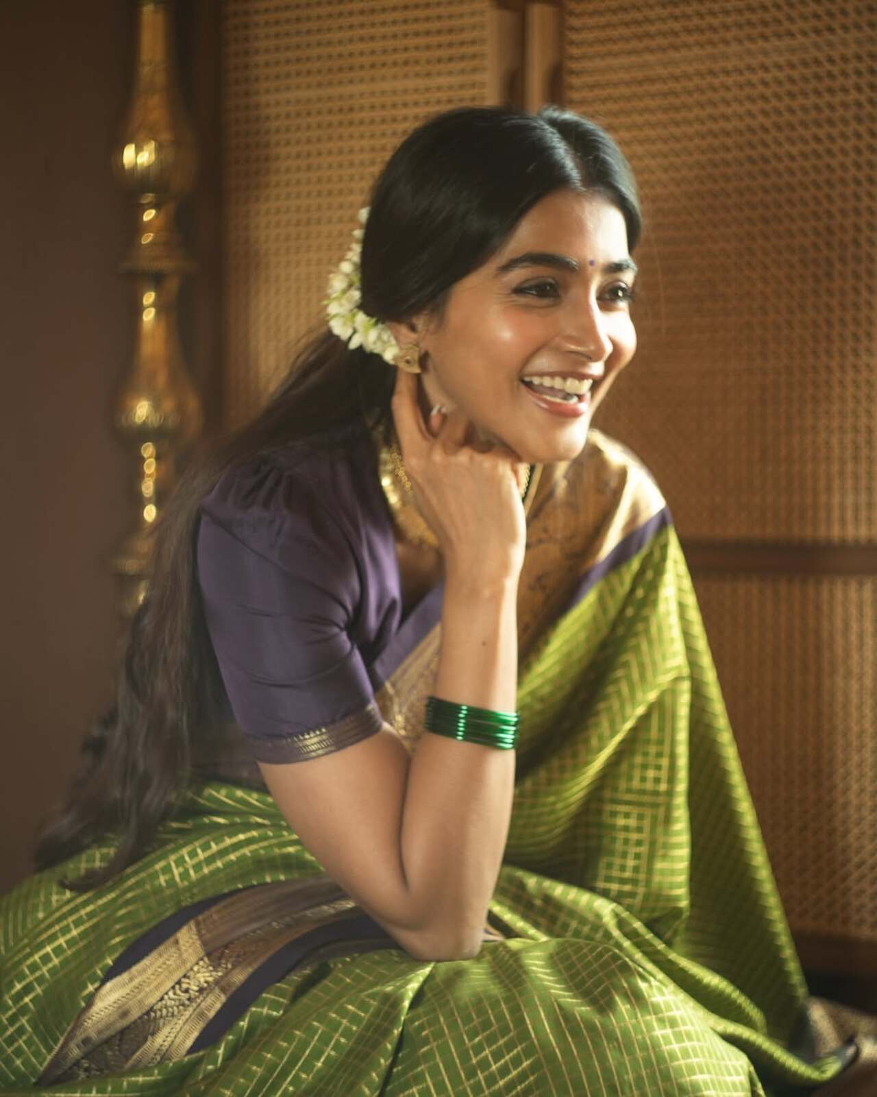 Paired with minimal makeup, green bangles, and jasmine-adorned hair, she proves that simplicity can be incredibly sophisticated. What adds to the beauty of this look is that, you can easily pull such a saree from your mother or grandmother's wardrobe and give it your own twist
 